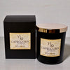 Capricorn Zodiac soy wax candle with packaging on a neutral background
