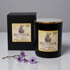 Black candle with 'Mother Goddess' label and packaging on a gray background