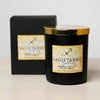 Black candle with gold lid and Sagittarius label on a white background