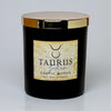 Black candle with gold lid and 'Taurus' label on a white background