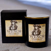 Scented candle labeled 'Wench' with a pirate-themed label and packaging.