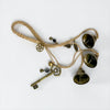 Witch's Bells made with cord and three brass coloured bells, one key, and charms